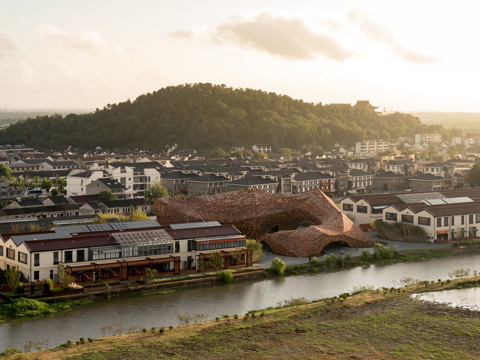 Kengo Kuma Completes a Monumental Building Clad in 3,600 Handmade Tiles